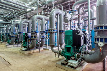 interior gas boiler room with multiple pipelines and pumps;