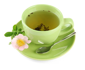 Cup of herbal tea with hip rose flower, isolated on white