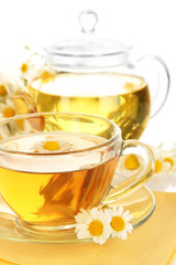 Cup of herbal tea with camomiles close up