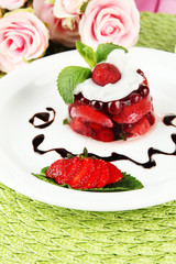 Tasty jelly dessert with fresh berries, on pink roses