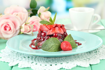 Tasty jelly dessert with fresh berries, on bright background