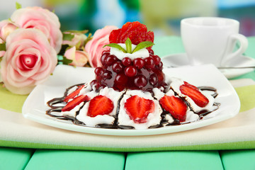 Tasty jelly dessert with fresh berries, on bright background