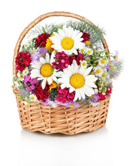 Beautiful bright flowers in wicker basket isolated on white