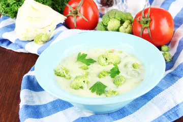 Cabbage soup in plates on napkin on wooden table