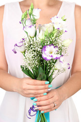 Obraz na płótnie Canvas Woman holding bouquet, close-up