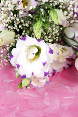 Bouquet of eustoma flowers on color wooden background