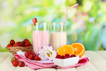 Delicious milk shakes with strawberries and orange