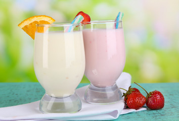 Delicious milk shakes with orange and strawberries