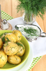 Boiled potatoes on platens on on napkins on wooden table