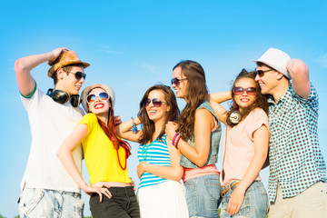 group of young people wearing sunglasses and hat