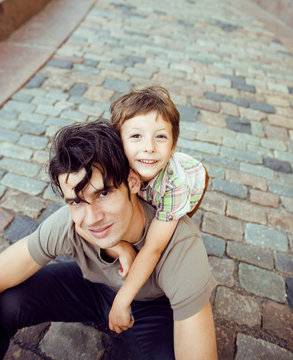 little son with father in city