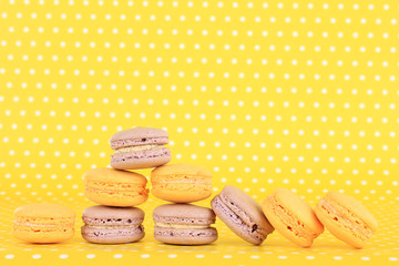 Gentle macaroons on yellow background
