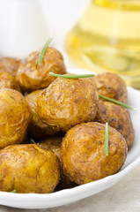 baked new potatoes with spices and rosemary in bowl