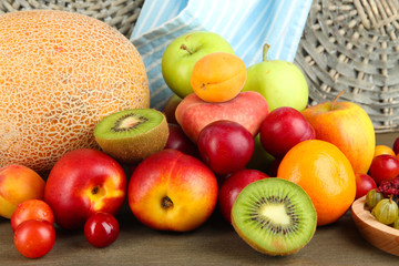 Assortment of juicy fruits, on wooden background