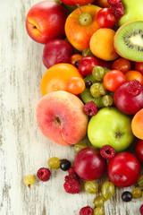 Assortment of juicy fruits, on wooden background