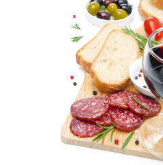 close-up of salami, ciabatta, olives and glass of wine on a wood