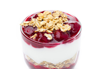 layered dessert with yogurt, granola and cherry on white