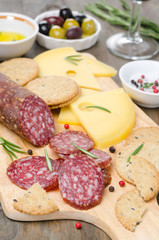 salami, cheese and crackers on a cutting board