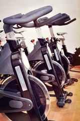Group of spinning bicycles at fitness studio