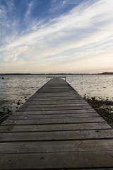 Fototapeta na wymiar a wooden bridge extending into sea
