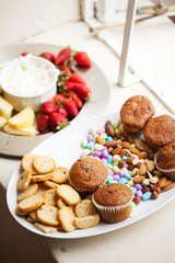 Assortment of snacks served on white platters