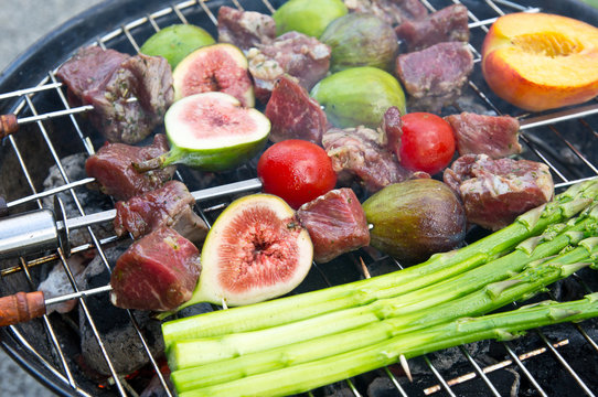 Lamb shashlik (grill) with figs, asparagus and tomatoes during p