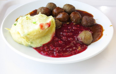 Food being eaten. Dinner meatballs with potatoes.