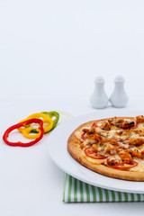Delicious homemade pizza with ham and vegetables.