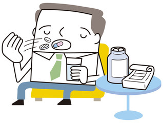 薬を飲むビジネスマン