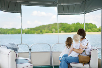 Happy family having fun on a sailboat