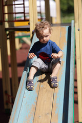 Kid sliding on a slide