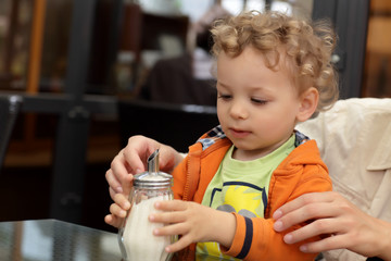 Toddler holding sugar bowl