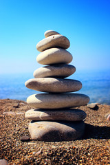 Pyramid of stones on beautiful beach