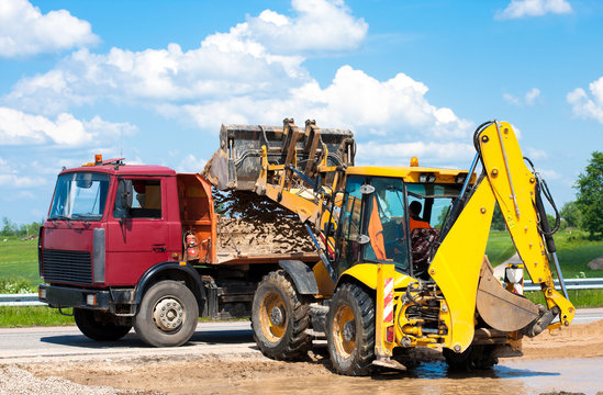 Wheel loader Excavator unloading sand into truck body