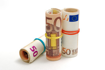 Three rolls of 50 euro bills isolated on a white background
