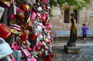 Love locks by a monument of Juliet - obrazy, fototapety, plakaty