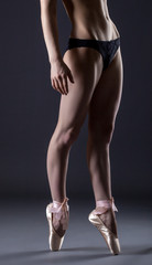 Image of slim ballerina's legs in pointes