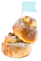 Rolled bun with cinnamon with paper message isolated on white ba