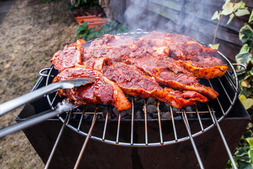 Flames grilling a steak on the BBQ