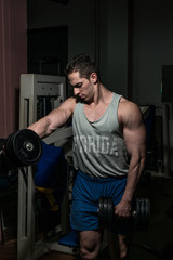 Fototapeta na wymiar bodybuilder doing heavy weight exercise for shoulder 
