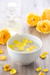 Bath with yellow rose petals