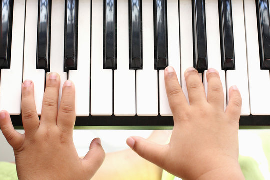 Hand of the boy. Playing the piano
