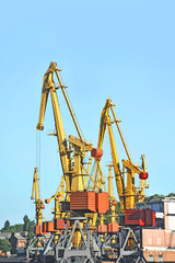 Fototapeta na wymiar Port cargo crane over blue sky background