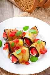 Eggplant rolls stuffed with cheese with a slice of tomato