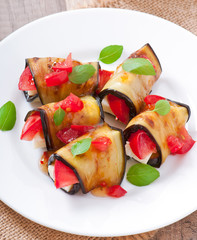 Eggplant rolls stuffed with cheese with a slice of tomato