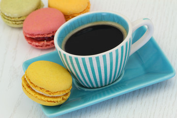 Lemon macaroon and cup of black coffee