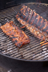Barbecue pork and beef ribs on a domestic barbeque