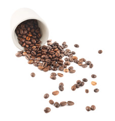 Fototapeta premium Spilled coffee beans from the cup isolated