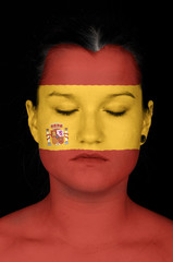 woman with the flag of Spain painted on her face.