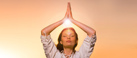 Yoga against the orange sky